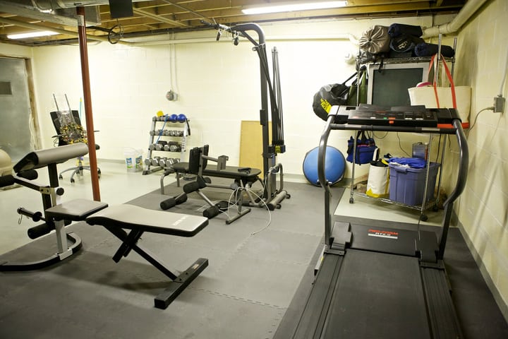 A picture of a beautiful home gym equipped on a grey floor