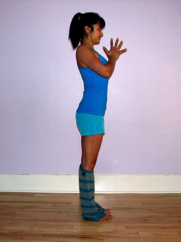 Yoga poses for mental health A girl wearing blue top doing yoga mountain pose