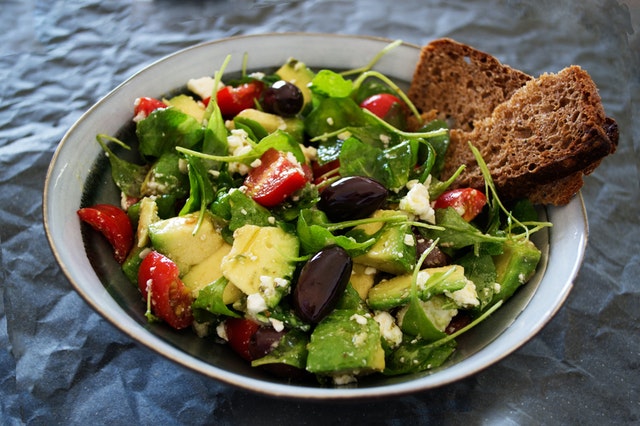 Salad eating: Vegetable salad with wheat bread
